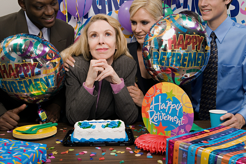 People celebrating a retirement with cake and balloons.